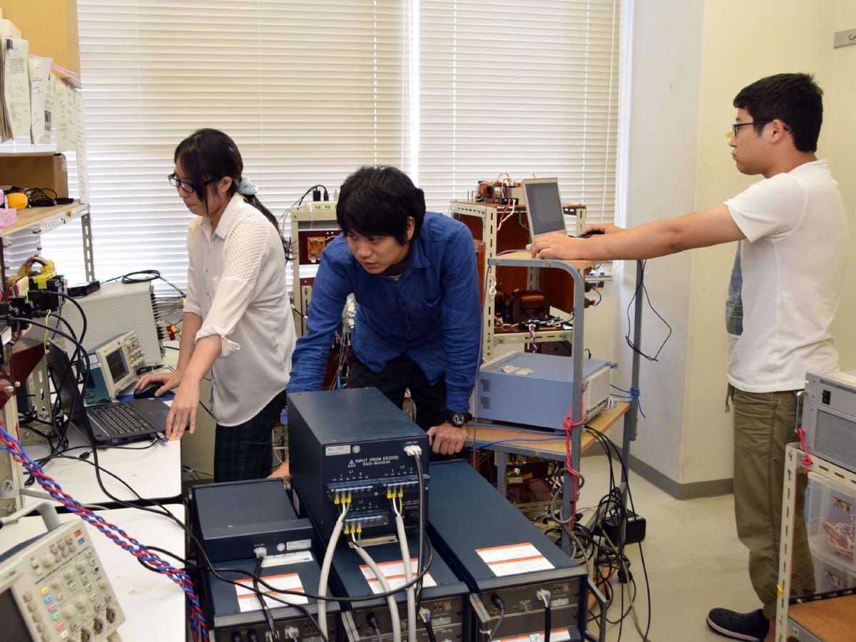 EV用スマートチャージャーのミニモデルによる実証に取り組む学生